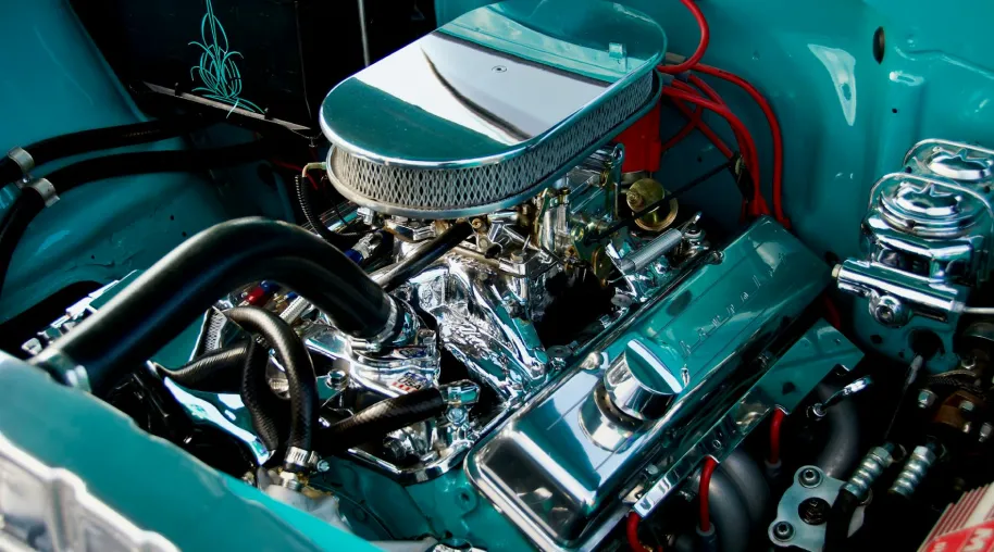 Car engine against a teal chassis